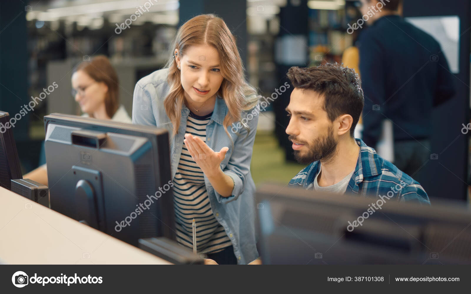 University Library: Bright Caucasian Girl and Talented Hispanic Boy Study for Exams As Team, Work on Assignment, Use Computer, Talk, Look for Solution, Explain Subject. College Students Work Together